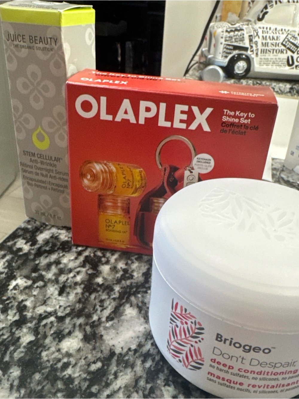 Briogeo skincare tube in gray and lime green packaging Olaplex